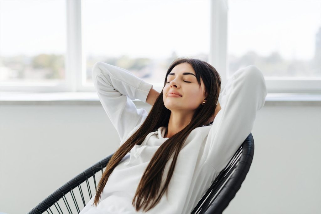 Woman relaxing on a chair enjoying improved air quality in Joplin, MO