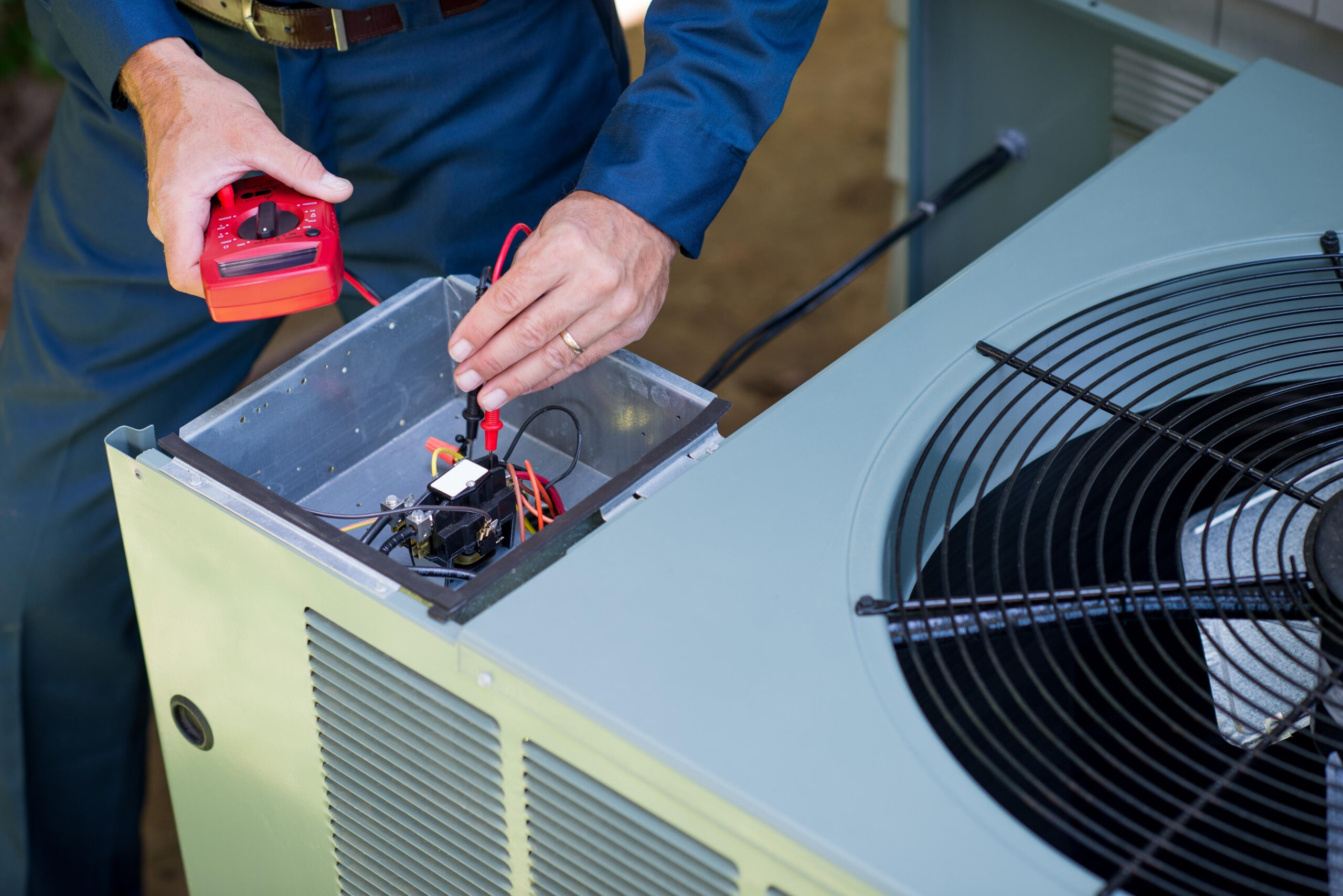 HVAC technician inspecting commercial air conditioning equipment near Joplin, Missouri